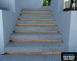 A staircase with illuminated steps, featuring soft LED lights along the edges of each step